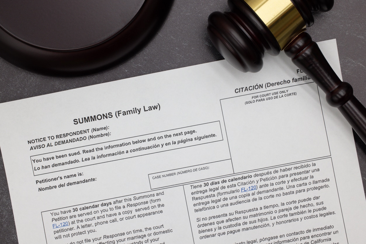 Family Law Summons to Appear legal form with gavel and block on slate desktop