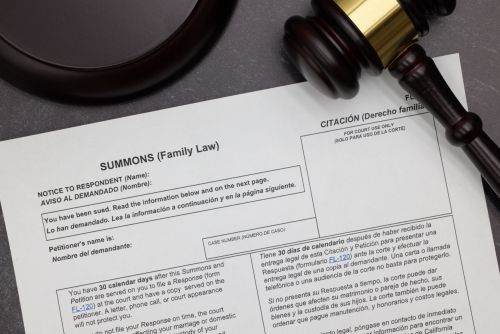 Family Law Summons to Appear legal form with gavel and block on slate desktop